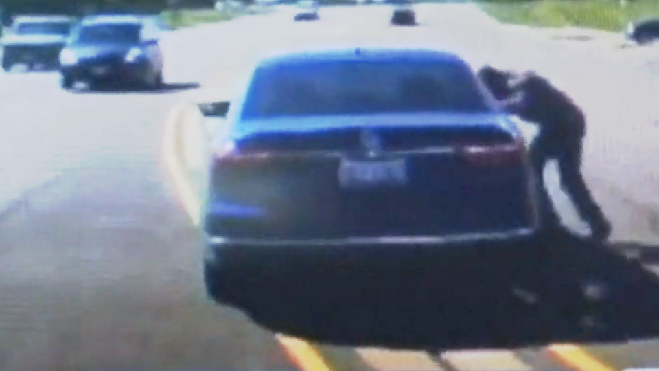 Dashcam video shows good Samaritan jump through car window to save driver